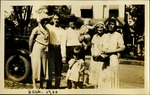Sept 1930 - Men and women and two children outside home near car