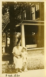 Sept. 30 - Woman and small child posing outside home near tree