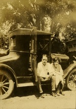 [1924] St. Louis County  Man and woman sitting outside car