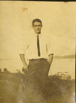 Man in tie standing by water