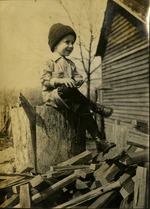 James- Joes Norris  Boy in beanie sitting on tree stump