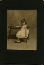 Young girl sitting in school desk, framed portrait