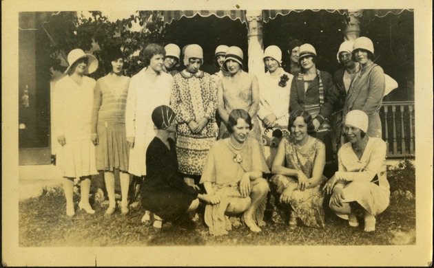 Women posing together near house