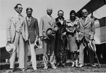 Edward E. Doc Dammers and group standing in front of plane