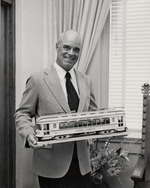 Man holding model trolley car of the City of Coral Gables