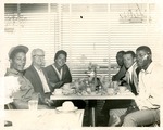 Althea Gibson sits with owner and other guests at the Hampton House restaurant