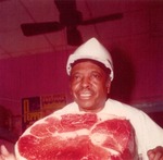 Neal Adams of Neal's Supermarket poses with a round steak