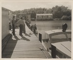 [1950/1959] Everglades National Park workers speak on a dock