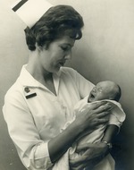 Nurse Evelyn Marie Merkle holding a baby, c. 1970