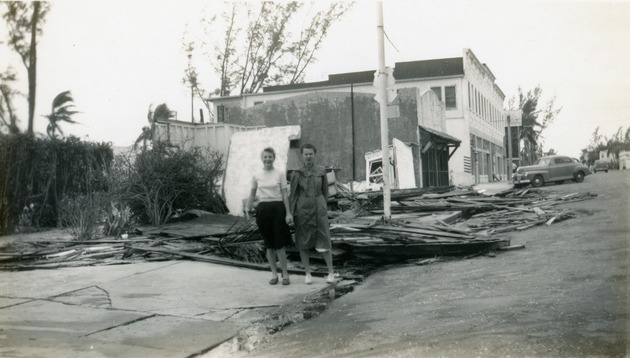 Two women standing amid Ocean Avenue hurricane damage, 1947