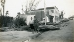 Two women standing amid Ocean Avenue hurricane damage, 1947