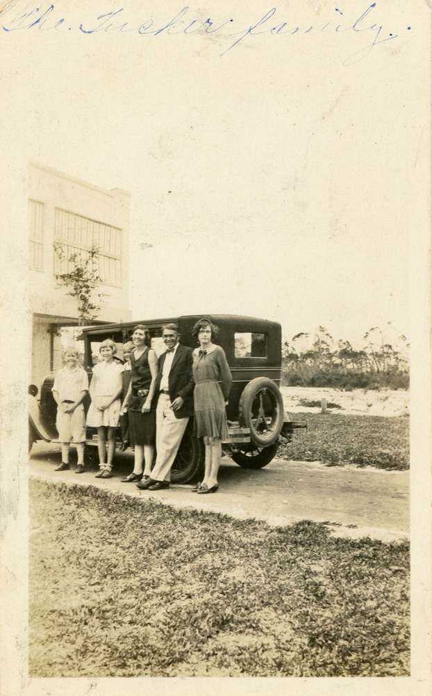 Tucker family standing by a car