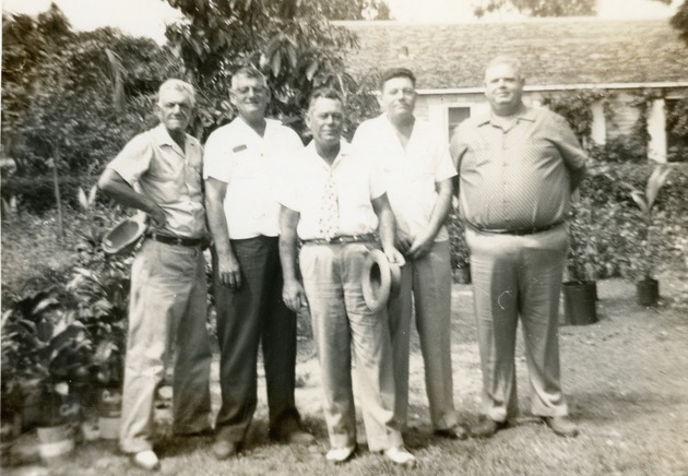 Group of men standing at 1105 North Andrews Ave.