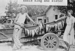 [1930/1939] Eddie King and sister with their catch of fish