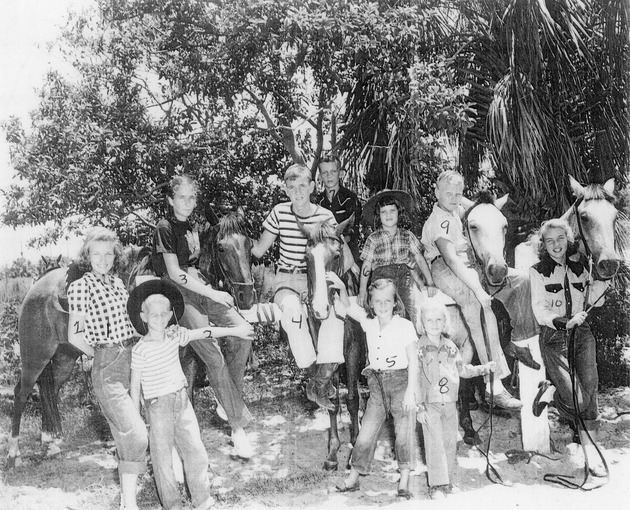 Boys and girls posed with ponies