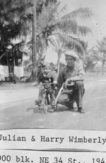 Julian Wimberly with son Harry on tricycle