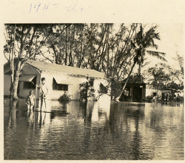 Two boys standing in flood water