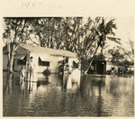 Two boys standing in flood water