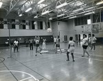Coed volleyball game in the Northeast High gym ca. 1974.