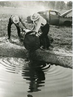 [1950/1959] Two Oakland Park firemen pour oil