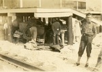 [1925/1929] Men gathered at car hit by train