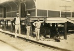 Man posing with car at depot