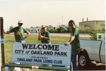 Color photograph of Lions Club members beside bus bench