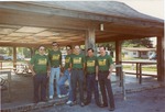 Color photograph of Lions Club members standing inside outdoor shelter
