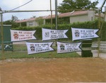 Color photo of pennants on fence at Thompson Field