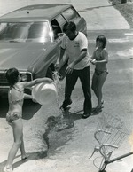 Children and adults at a Recreation Dept. car wash