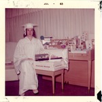[1963] Gail Goodbread in graduation cap and gown, seated