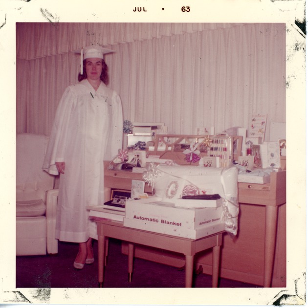 Gail Goodbread in graduation cap and gown, standing