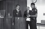 Bob Scallan awarding Oakland Park Police Officer
