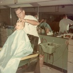 Walter Lacey giving Greg McClain's his first haircut, 6 April 1967