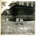 Children playing in yard of house, 1911