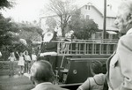 [1970/1979] Santa waves from the back of a fire engine, c. 1970