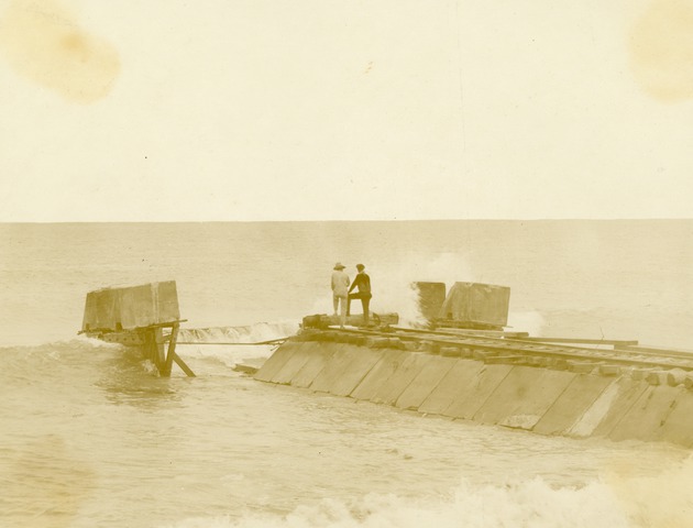 Two men on north jetty of Boynton Inlet, 1925