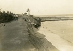 Two men walking on damaged Ocean Boulevard near Boynton Inlet, 1927