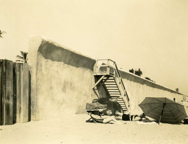 Sun bathers next to seawall, c. 1929