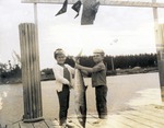 Two children with large fish, 1968