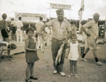 Chef Alfredo with two children and fish, 1967