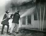 Firemen fighting a blaze, 1968