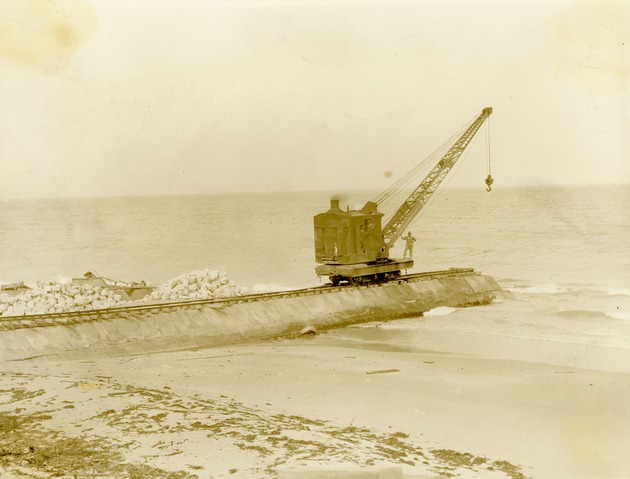 Large crane and workman building Boynton Inlet, 1925