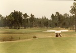 Golf cart on golf course, 1987