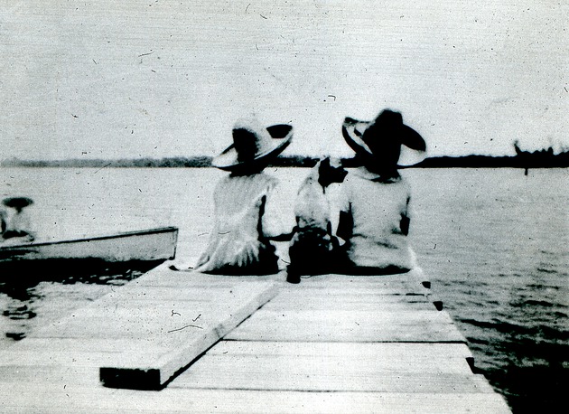 Two children and dog on dock, c. 1925