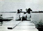 Two children and dog on dock, c. 1925