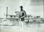 [1906/1909] Man standing on shore in front of steamboat Wanderer, c. 1906