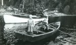 Two children in rowboat, c. 1920
