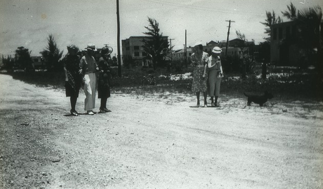 Walking in Lake Worth with dog, c. 1925