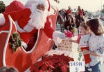 [1982-12-05] Santa reaching out to a child from a float in the Boynton Beach Florida holiday parade, 1982